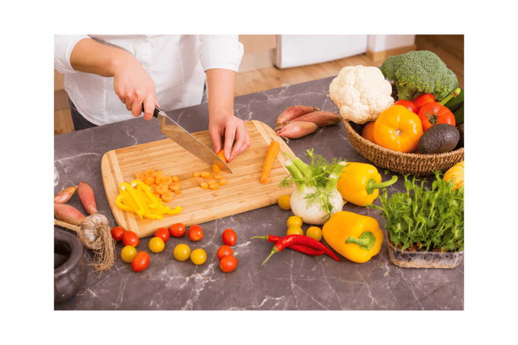 a person cutting vegetables on a cutting board