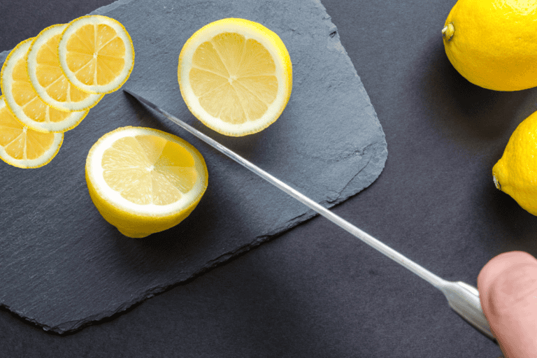a lemon cut in half with a knife